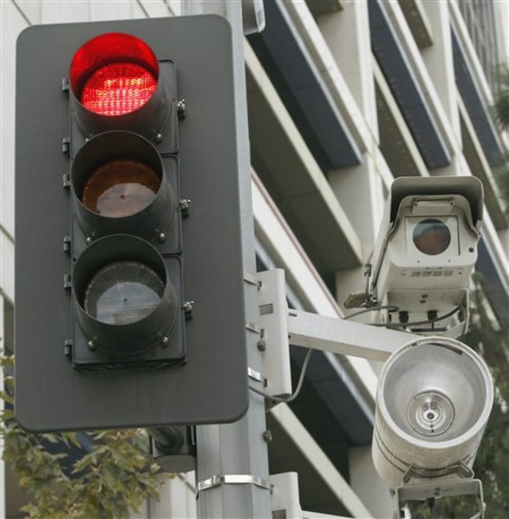 A red light camera set up in Los Angeles. One out of every five American lives in a community that outsources its enforcement of traffic violations caught by red light cameras to private vendors, according to a report by a consumer advocacy group. In many cases, those vendors a direct financial incentive to issue more tickets and to try to block alternative means of traffic enforcement.